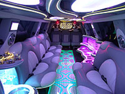 Chauffeur stretched pink Hummer H2 limousine hire interior in UK